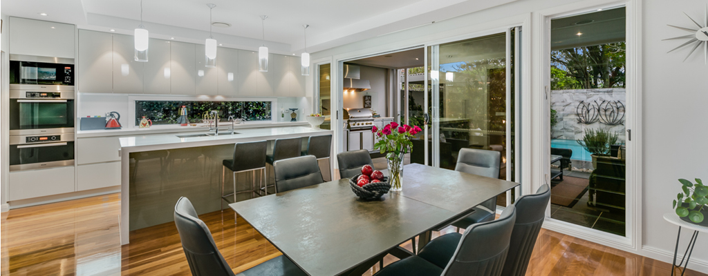 Modern kitchen and dining room with timber floors is an example of real estate sold in 2021 in Indooroopilly